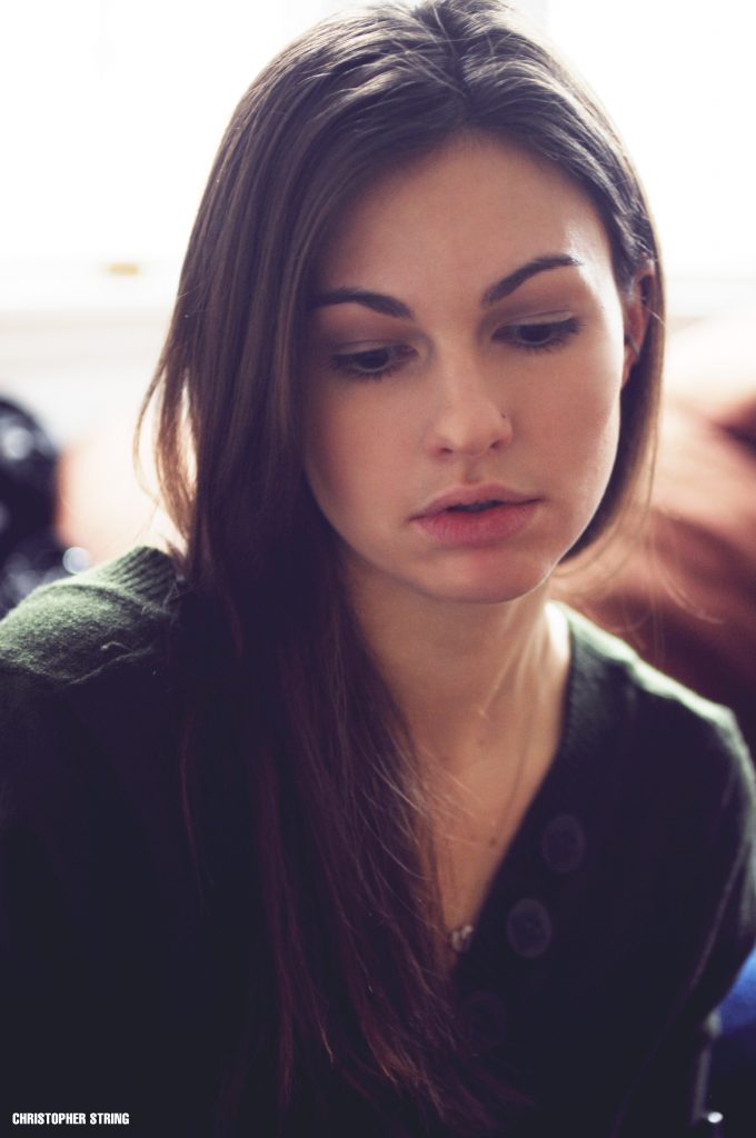 Woman looking away from camera lit from behind