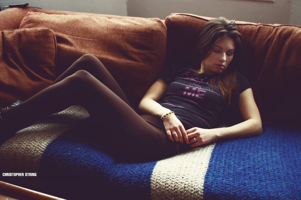 girl laying on couch looking off