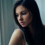 Woman looking out of window over her shoulder