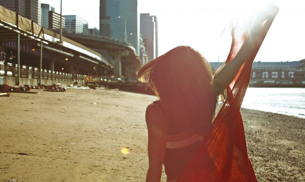 Woman in Red Scarf dances on the beach by Christopher String