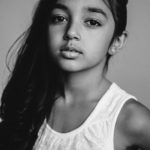 Young girl with dark hair in portrait session by Christopher String