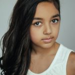 Young girl with dark hair in portrait session by Christopher String